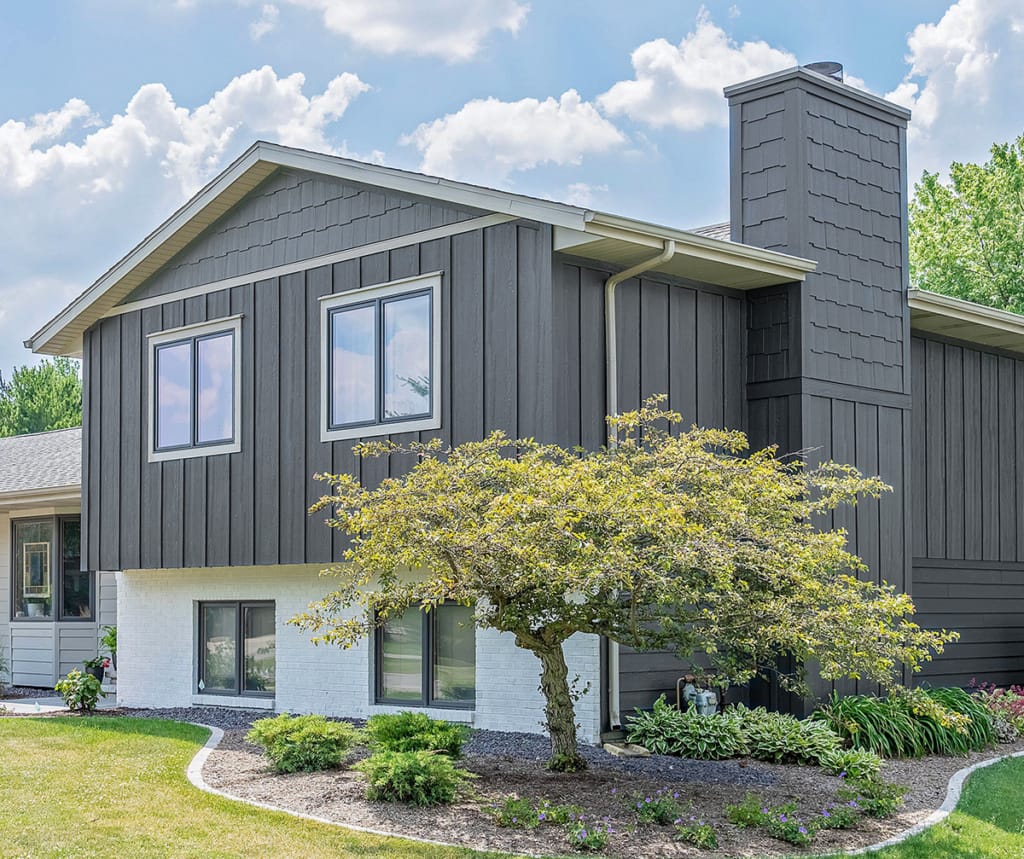 a mix of shake siding, lap siding, and board & batten vertical siding in a gray siding color